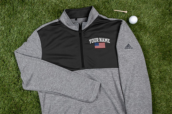 Adidas pullover personalized with a flag on golf lawn with golf tee
