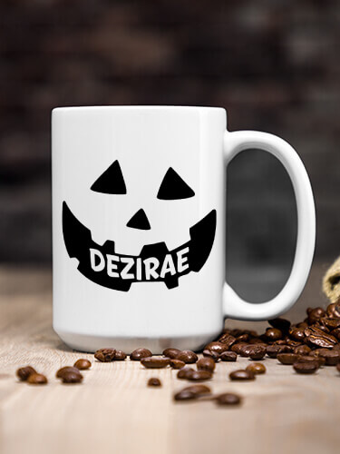 A400 Pumpkin - Personalized white ceramic mug with jack O lantern design on wooden table with scattered coffee beans.