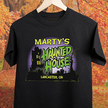 A317 Haunted House - Your Name Haunted House, Your Location, in front of a classic haunted house, on a black tee shirt.