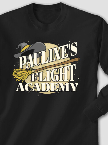 Your Name Flight Academy with a broom and witch's hat in front of a full moon on a black long sleeve tee.