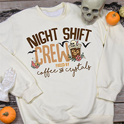 Your Name Crew, Fueled By Coffee And Crystals, next to a cold brew with a skull on top, and flanked by bats on an off white sweatshirt.