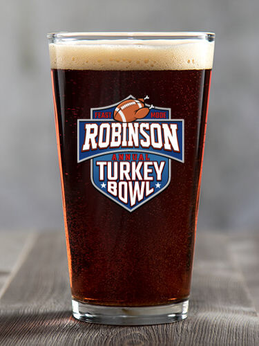 A633 Turkey Bowl - A football with turkey legs and the phrase feast mode, above Your Name Annual Turkey Bowl in a football style logo, on a color printed pint glass.