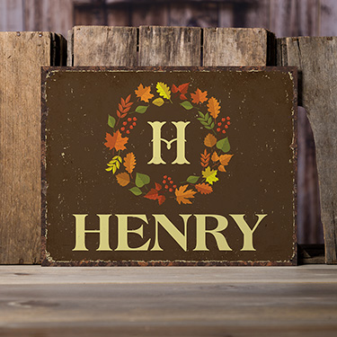 A859 Fall Monogram - Monogram made of colorful fall leaves above Your Name on a tin sign.