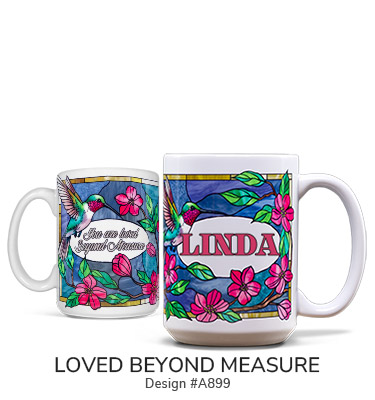 Loved Beyond Measure - Two ceramic coffee mugs with a wraparound fuchsia, spring flower design and hummingbirds. Front of mug says Your Name and back of mug says You Are Loved Beyond Measure.